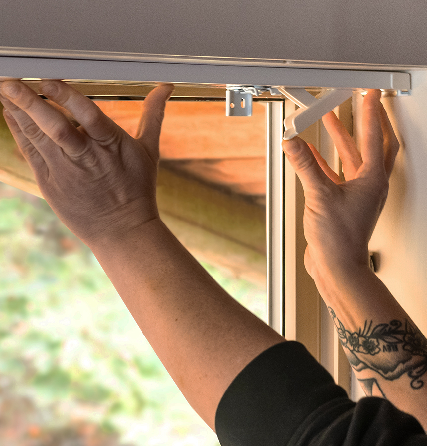 Image of person measuring a window
